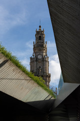 Clerigos tower, city of Porto. Blue sky with clouds. Old and new architecture