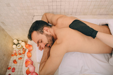 Handsome man relaxes on a marble massage table in a hammam. Hammam, Turkish bath, pilling