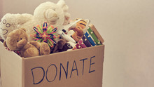 Donation Box With Children Toys. Woman Collects Toys For Charity.