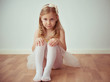 © spass - Cute little blonde girl sitting in ballet tutu