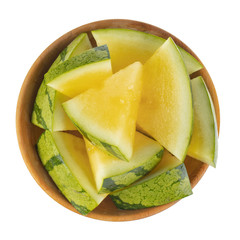 Wall Mural - heap of slices yellow watermelon in wooden plate isolated on white background