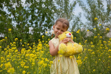 Portrait of a little cute girl with a teddy bear in her hands