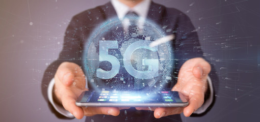 Poster - Businessman holding a 5G connection with data surrounding - 3d rendering