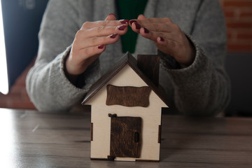 Wall Mural - woman hand key with house model