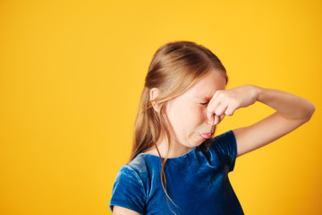 Little Redhead Girl Covering Nose For Bad Smell