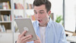 © stockbakers - Excited Young Man in Surprise Looking on Tablet