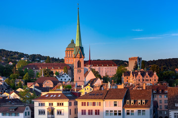 Fototapete - Aerial view over roofs and towers of Old Town of Zurich, the largest city in Switzerland at sunset.