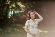© Kristina89 - Portrait of a beautiful young pregnant woman in eco dress. Motherhood. A family. Summer.
