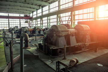 Wall Mural - Old abandoned factory with rusty remains of industrial machinery in workshop