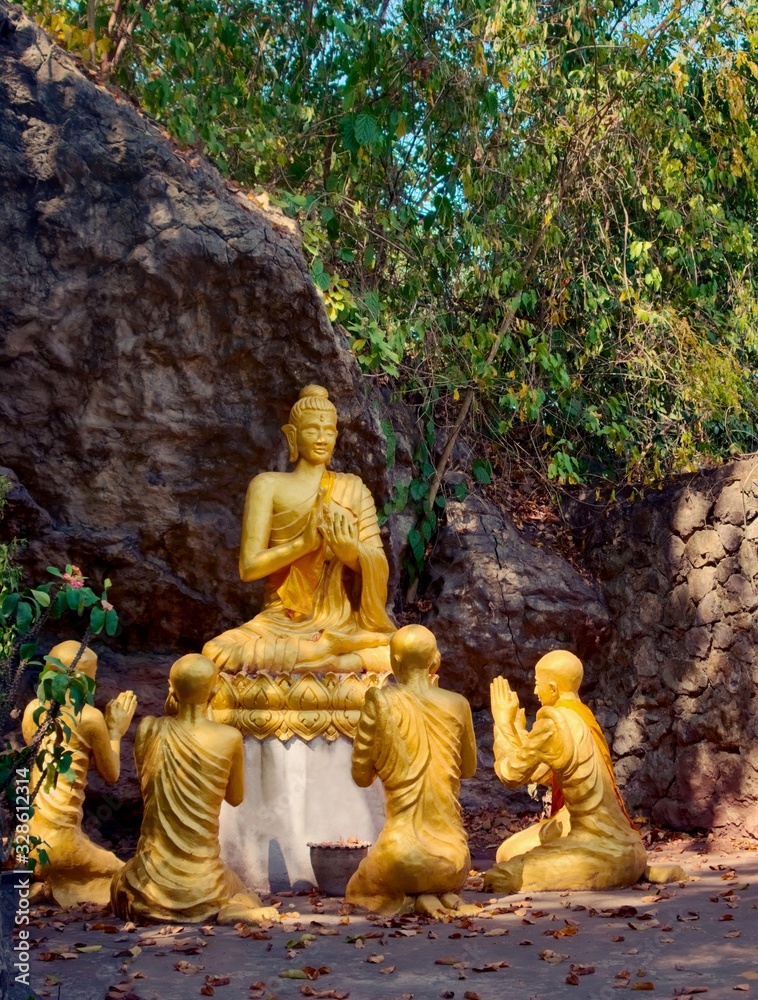 Golden statues of Buddha and disciples at Mount Phou Si, in Luang Prabang, Laos. - obrazy, fototapety, plakaty 