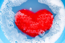 Soaking Heart Red Pillow In Laundry Detergent Water Dissolution Before Washing.  Laundry Concept,