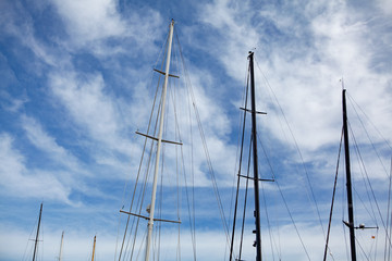 yacht masts and rops against blue sky