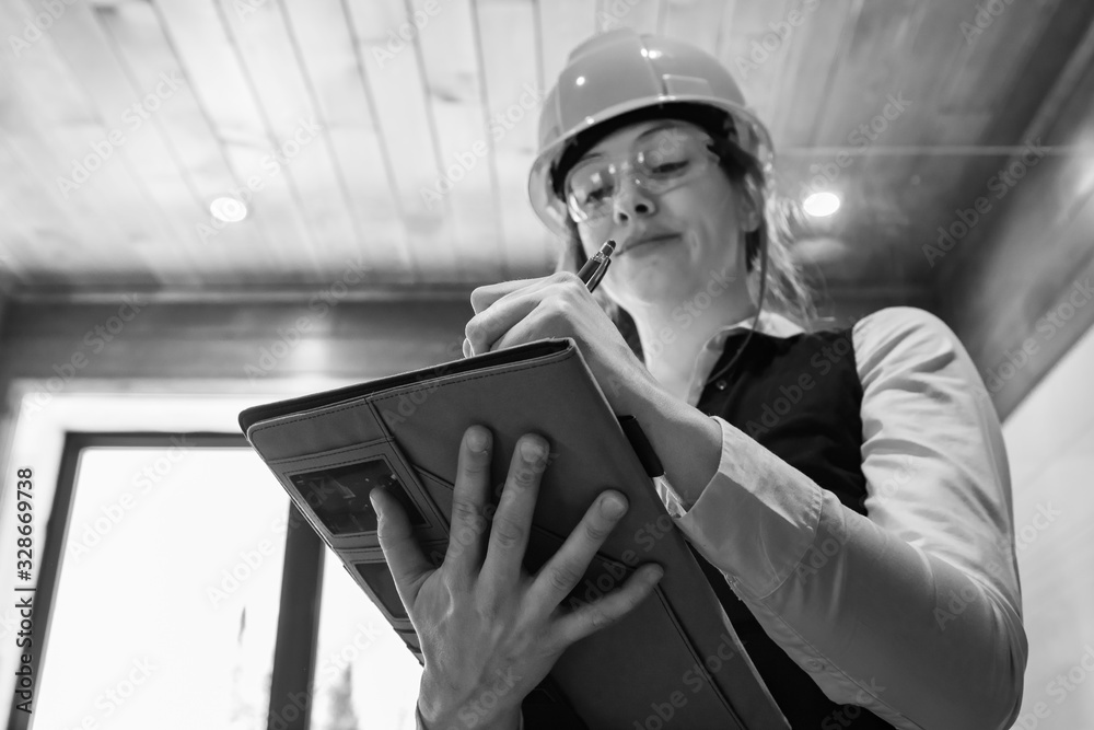 black and white low angle portrait of a female construction inspector ...