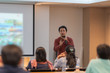 © Pornchai - Asian Speaker is speaking on the stage over the presentation screen in the education seminar