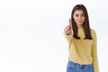 Hold it not so fast. Skeptical and serious-looking young confident woman prohibit action, forbid something, scolding person with disapproval expression, shake finger in stop gesture