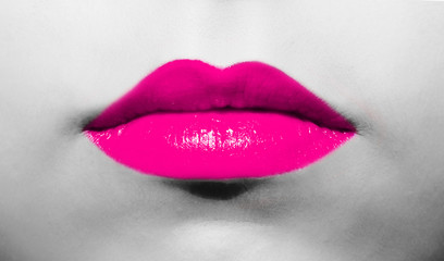 Wall Mural - Female lips close-up with burgundy lipstick bright juicy color on a background of black and white face.