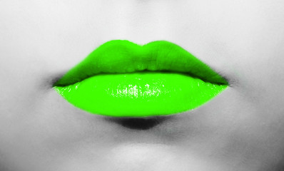 Wall Mural - Female lips close-up with light green lipstick bright juicy color on a background of black and white face.