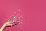 Fototapeta  - Falling confetti on bright pink background