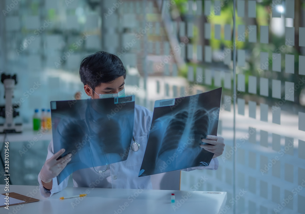 Doctor examining a lung radiography, Doctor looking chest x-ray film ...
