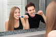 © Proxima Studio - Couple brushing teeth in bathroom