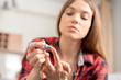 © Proxima Studio - Young woman measures blood sugar level.