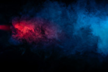 Abstract Texture Of Backlit Smoke In Red Blue On A Black Background.