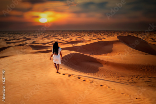 Dubai dessert sand dunes, couple on Dubai desert safari,United Arab Emirates, woman vacation in Dubai