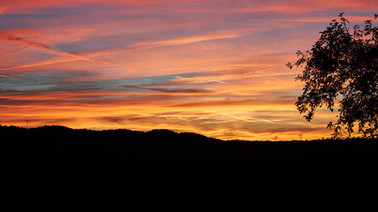 Panorama of a mystically glowing evening sky at sunset time