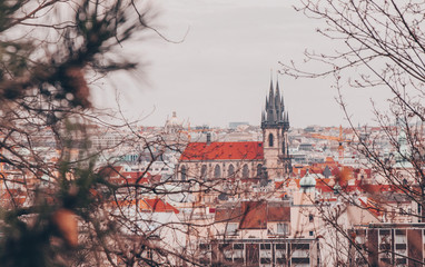 Moody Photo of Prague panorama with medieval church and red roofs taken from Letná hill on the moody February afternoon