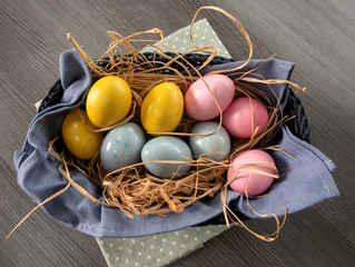 Colorful painted easter eggs in brown basket