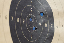 Close Up Of A Shooting Target And Bullseye With Bullet Holes