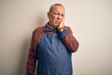 Sticker - Senior handsome baker man wearing apron standing over isolated white background thinking looking tired and bored with depression problems with crossed arms.