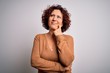 © Krakenimages.com - Middle age beautiful curly hair woman wearing casual sweater over isolated white background with hand on chin thinking about question, pensive expression. Smiling with thoughtful face. Doubt concept.