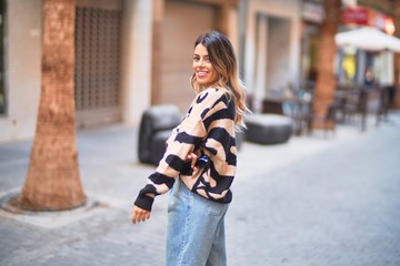 Young beautiful woman smiling happy and confident. Standing and walking at town street