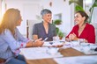 © Krakenimages.com - Meeting of middle age women having lunch and drinking coffee. Mature friends smiling happy using smartphone at home on a sunny day