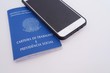 © Blossom Stock Studio - Brazilian work card and social security document (carteira de trabalho) and smartphone. Digital work card concept.