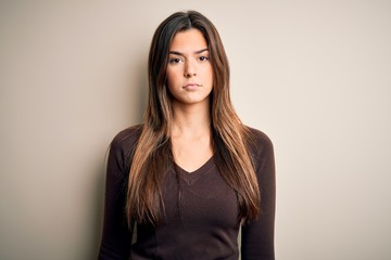 Sticker - Young beautiful girl wearing casual sweater standing over isolated white background depressed and worry for distress, crying angry and afraid. Sad expression.