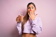 © Krakenimages.com - Young beautiful fitness woman drinking protein chocolate milkshake before gym cover mouth with hand shocked with shame for mistake, expression of fear, scared in silence, secret concept