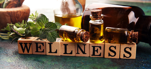 Wall Mural - Homegrown and aromatic herbs with rosemary and basil. Wellness sign with wooden cubes