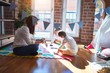 © Krakenimages.com - Beautiful teacher and toddlers learning maths using numbers game around lots of toys at kindergarten