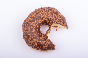 chocolate donut with chocolate crumbles, bitten and isolated