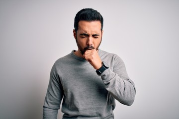 Wall Mural - Young handsome man with beard wearing casual sweater standing over white background feeling unwell and coughing as symptom for cold or bronchitis. Health care concept.