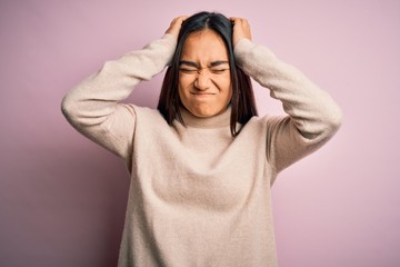 Sticker - Young beautiful asian woman wearing casual turtleneck sweater over pink background suffering from headache desperate and stressed because pain and migraine. Hands on head.