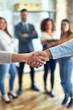 © Krakenimages.com - Group of business workers standing together shaking hands at the office