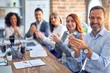 © Krakenimages.com - Group of business workers smiling happy and confident. Working together with smile on face looking at the camera applauding at the office