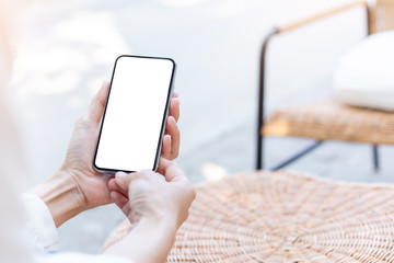 Mockup image blank white screen cell phone.woman hand holding texting using mobile on desk at coffee shop.background empty space for advertise text.people contact marketing business,technology