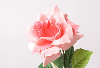 Pink colorful textile rose closeup on white background