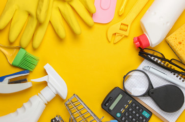 Composition for copy space of household utensils, work tools, cleaning products and stationery on yellow background. Top view