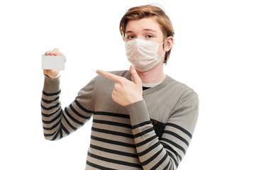 Isolate photo of Caucasian guy in medical mask with a business card in his hands