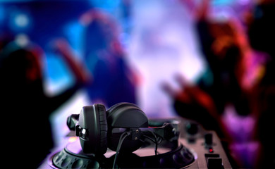 Wall Mural - DJ Spinning, Mixing, and Scratching in a Night Club. DJ playing music at mixer . Closeup. Party.